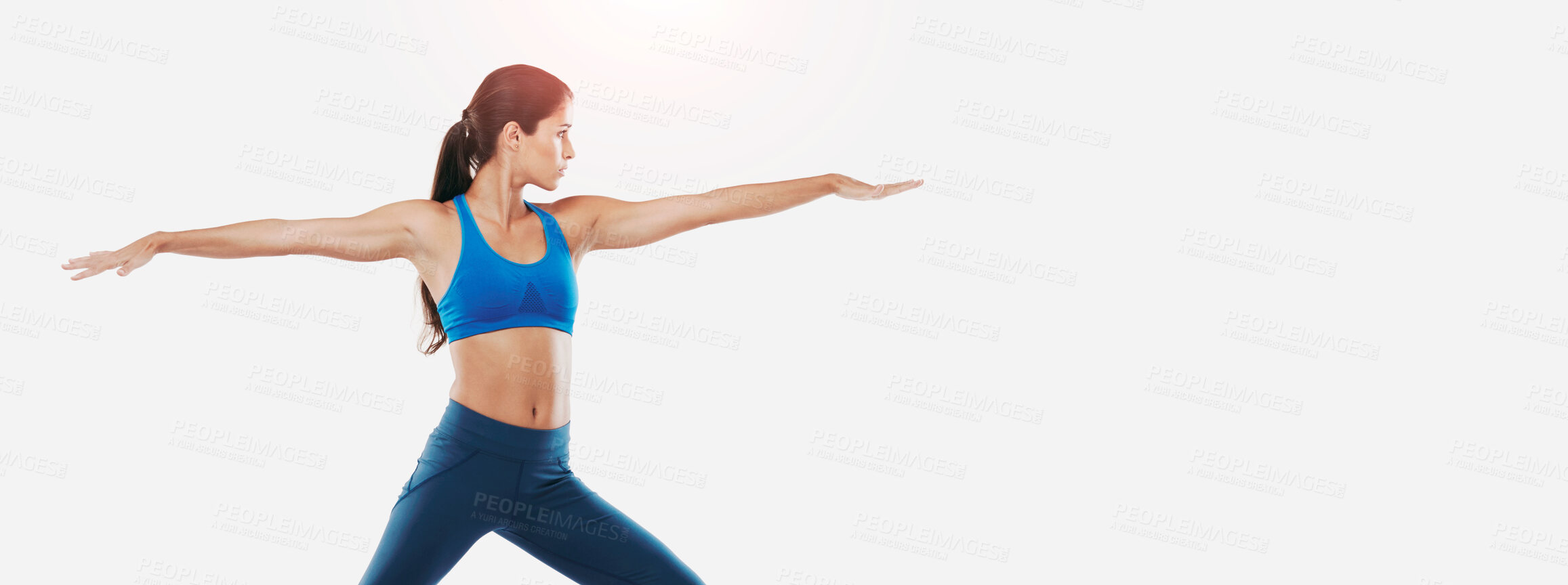 Buy stock photo Shot of a sporty young woman practicing yoga against a white background