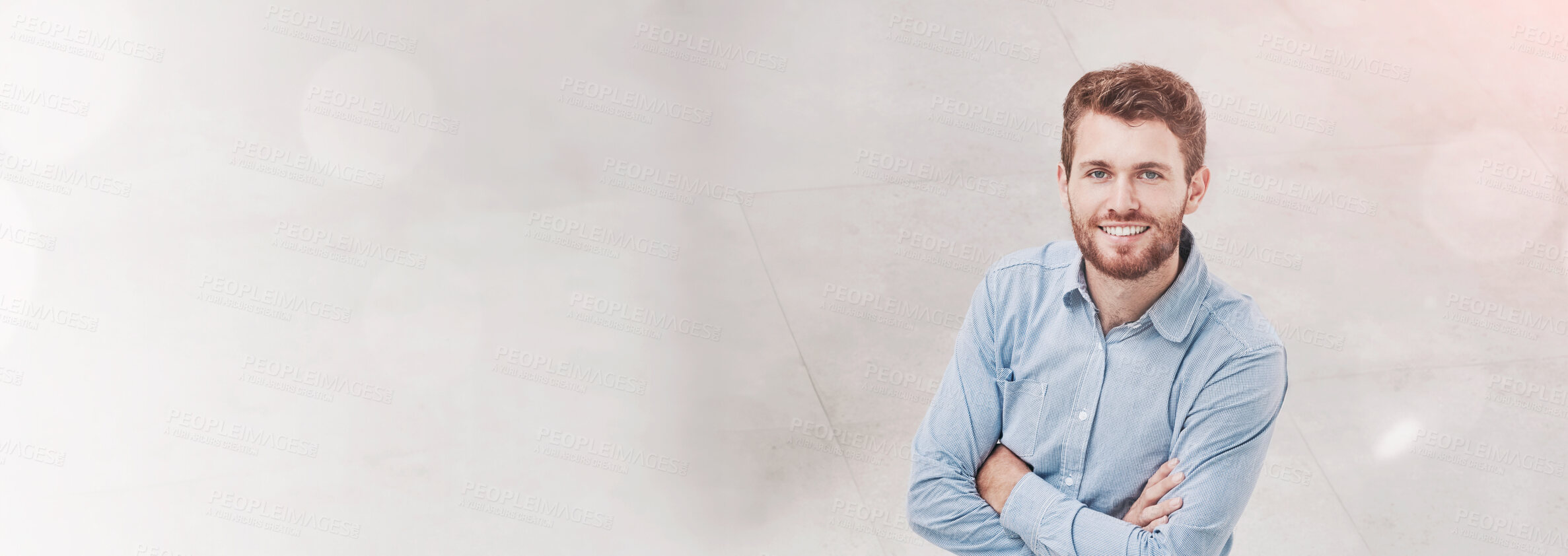 Buy stock photo High angle portrait of a young businessman standing in an office with colleagues walking around him