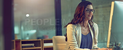 Buy stock photo Cropped shot of a young businesswoman working late on a computer in an office