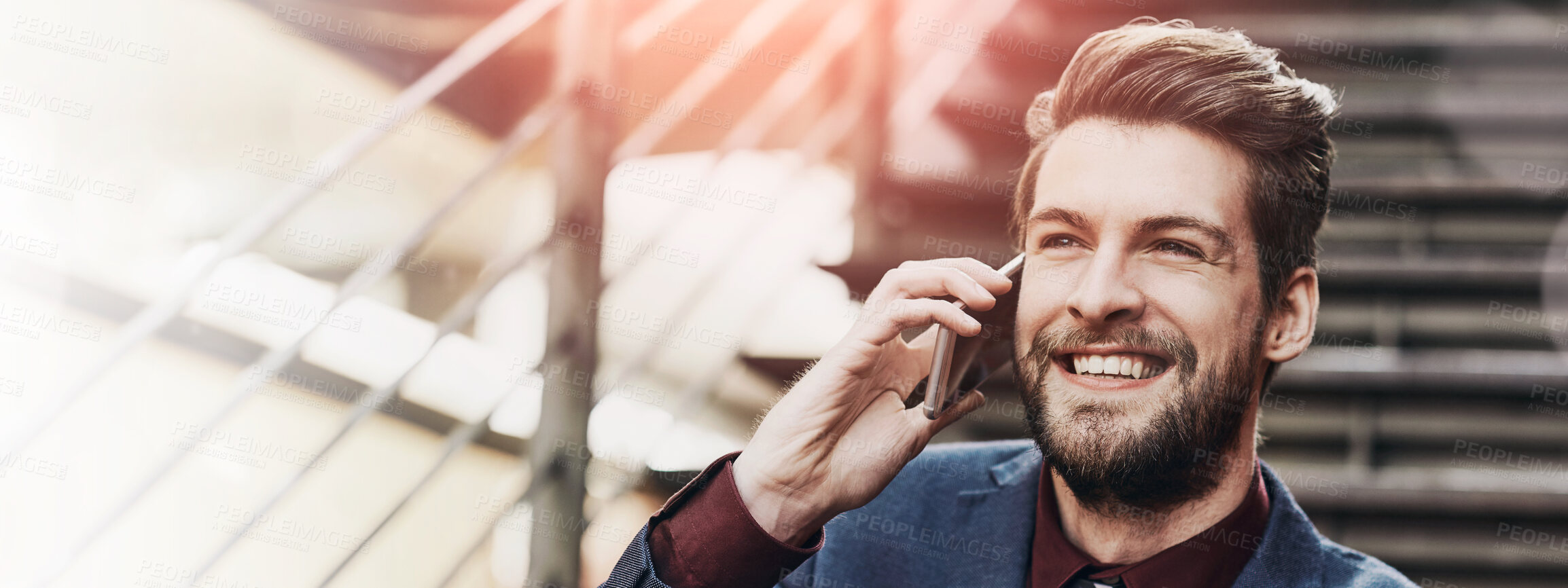 Buy stock photo Portrait of a happy young businessman using his phone while out in the city