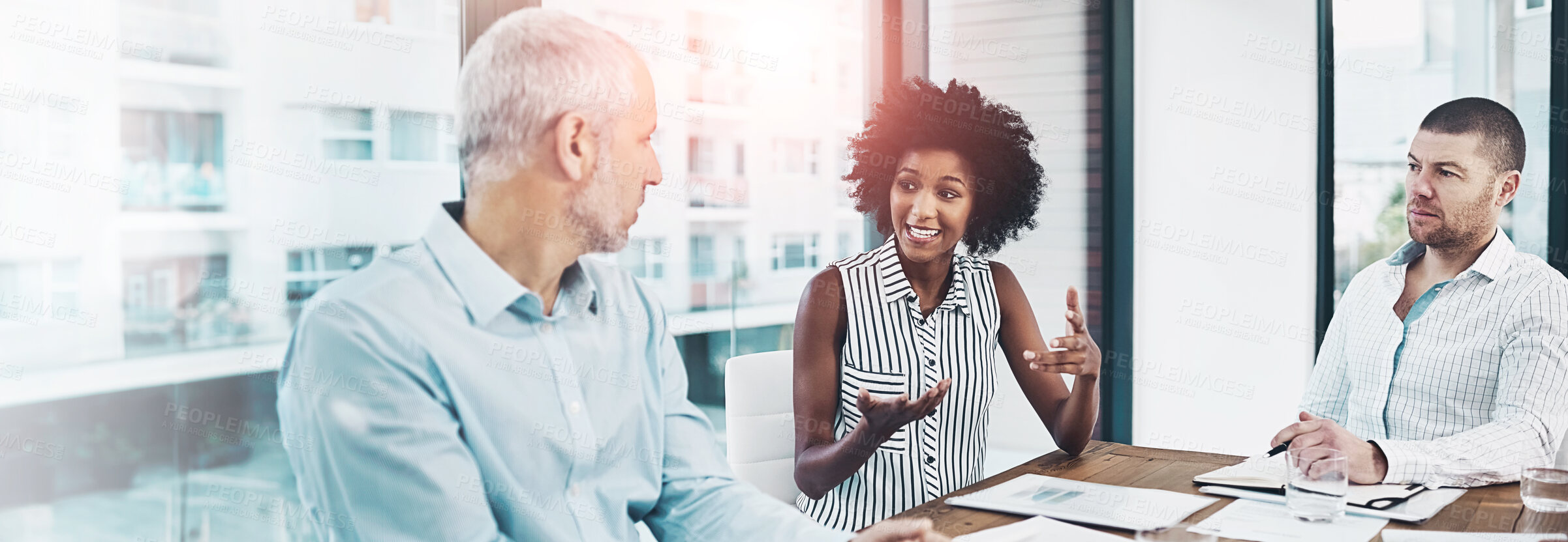 Buy stock photo Shot of a group of coworkers talking together over a digital tablet in a meeting in an office