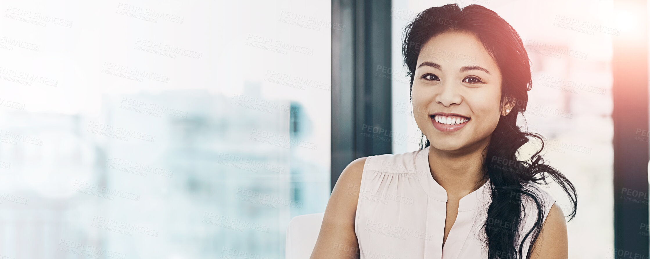 Buy stock photo Portrait of a smiling young businesswoman reading paperwork while sitting in an office