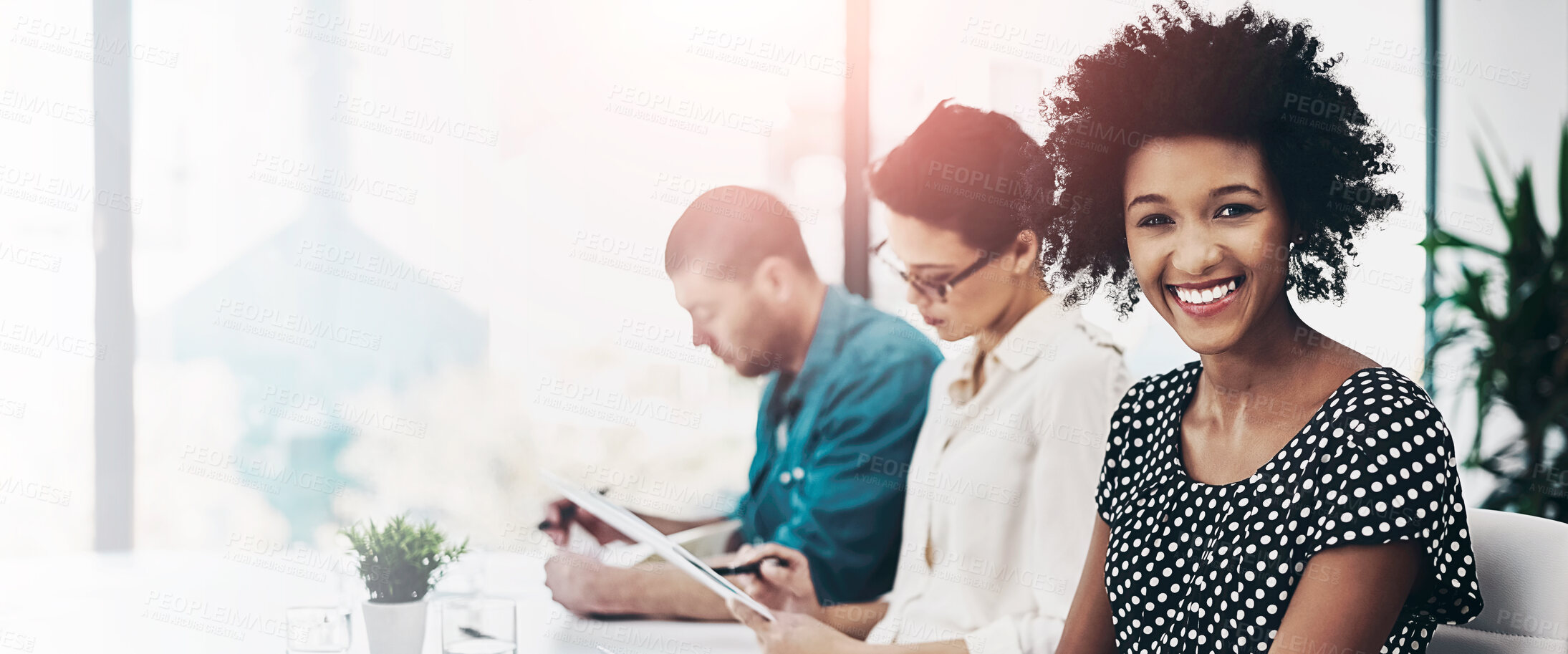 Buy stock photo Portrait of a smiling businesswoman sitting in a boardroom using a digital tablet with colleagues in  the background