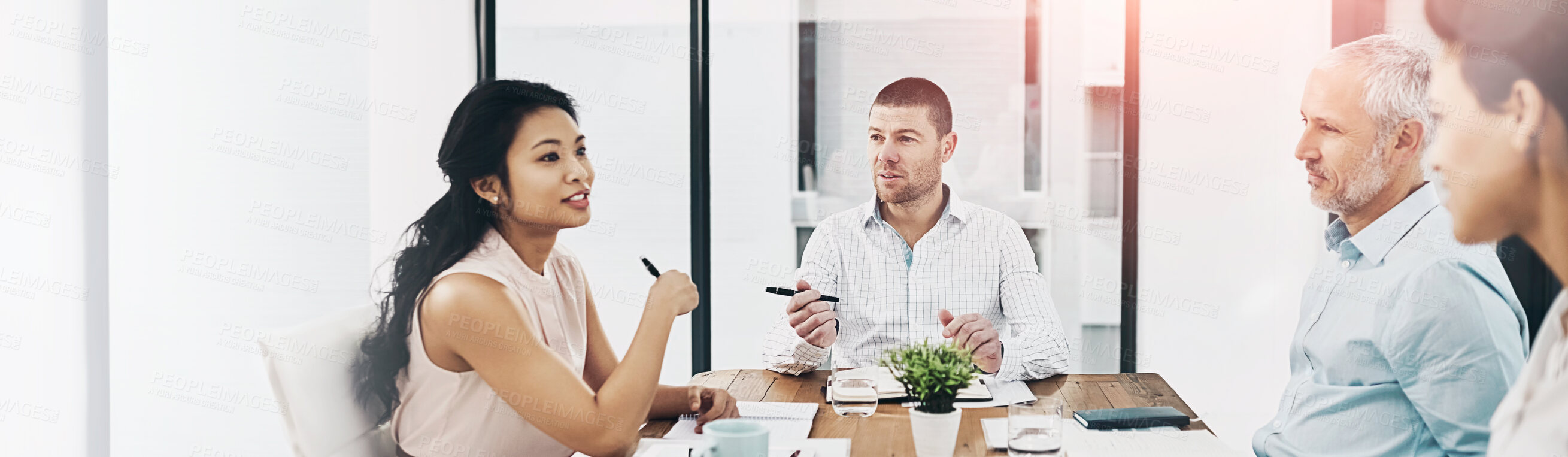 Buy stock photo Shot of a group of coworkers talking together in a meeting in an office