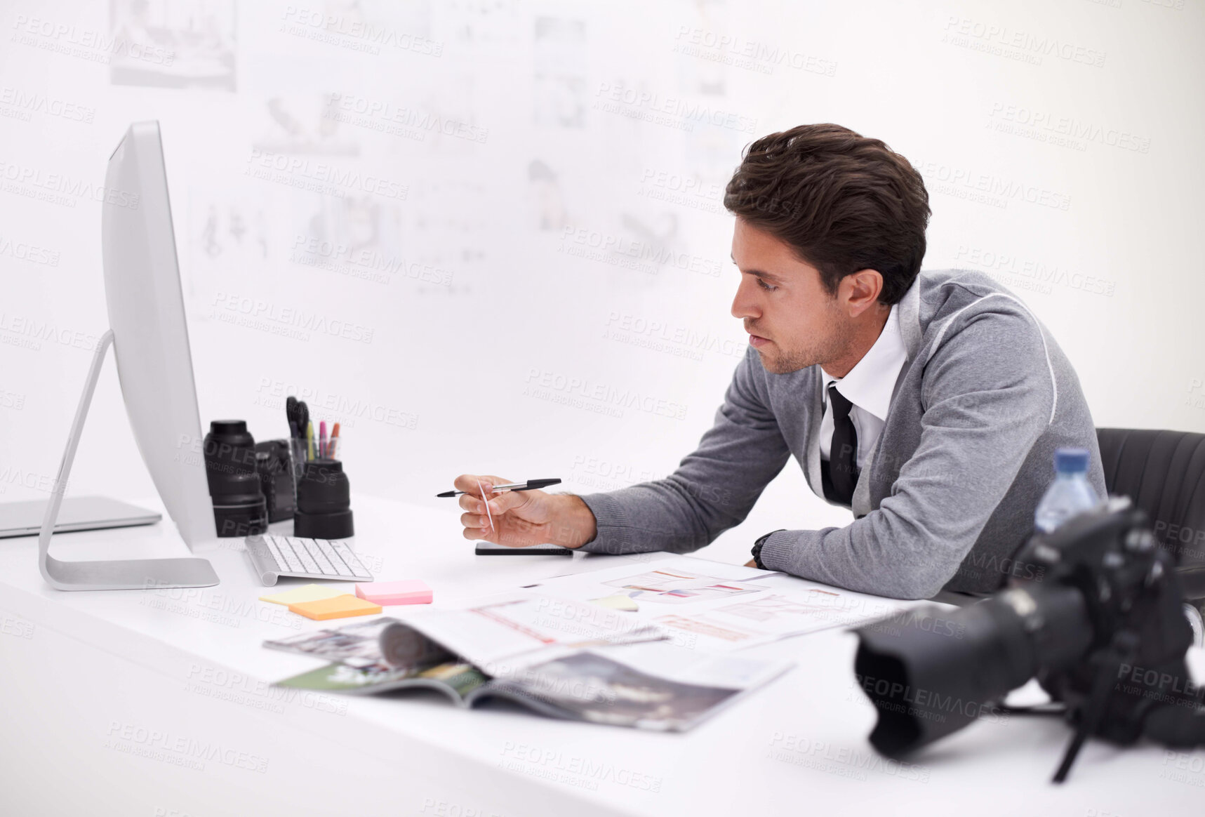 Buy stock photo A photographer looking at his images in his office