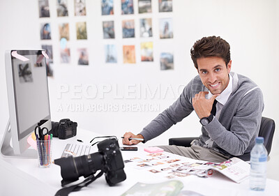 Buy stock photo A photographer looking at his images in his office