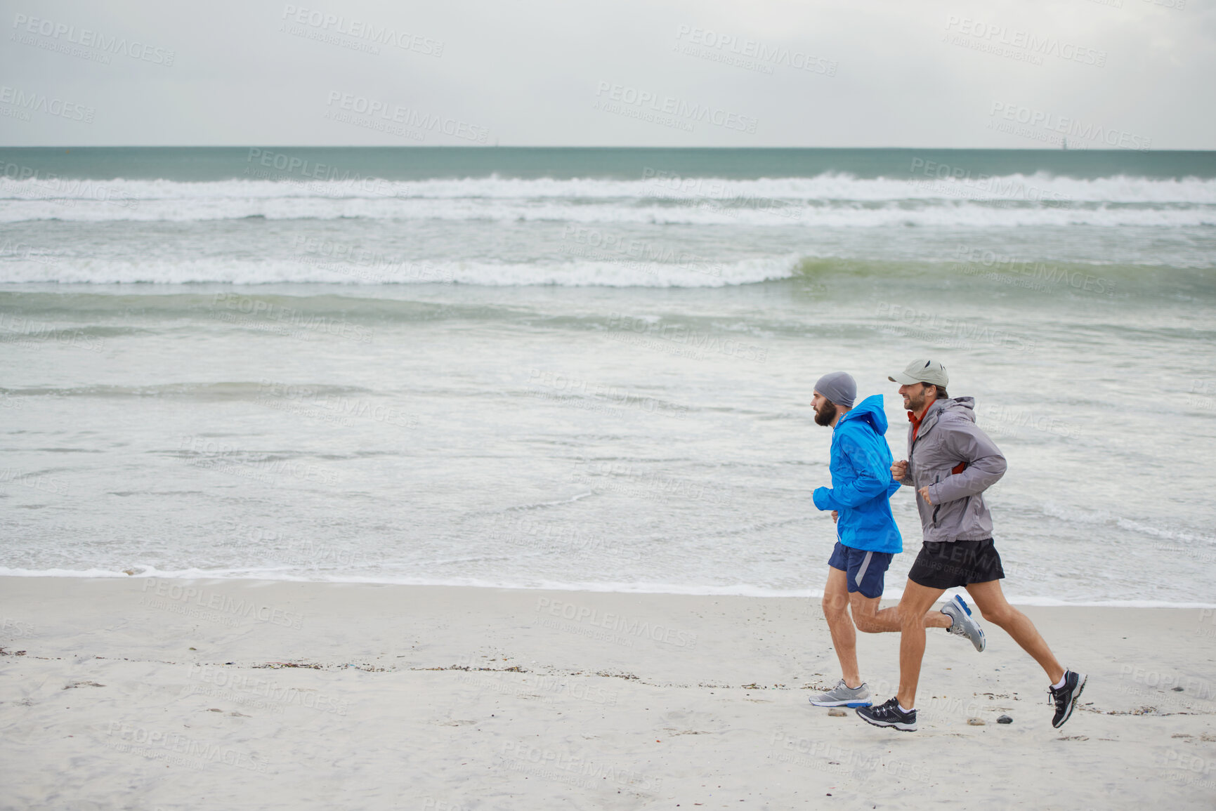 Buy stock photo Ocean waves, men and running on beach, sand and fitness for wellness and gym wear on coast together. Male athletes, jog and training for seaside, health and outdoor for sport and exercise in workout