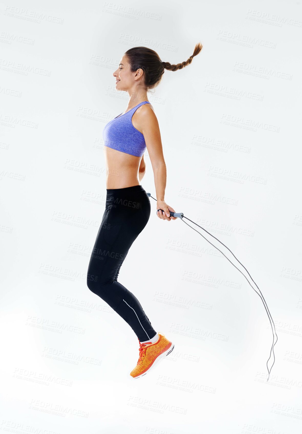 Buy stock photo Woman, fitness and air with jump rope for exercise, workout or training on a white studio background. Active female person or athlete with string or wire for skipping, endurance or cardio practice