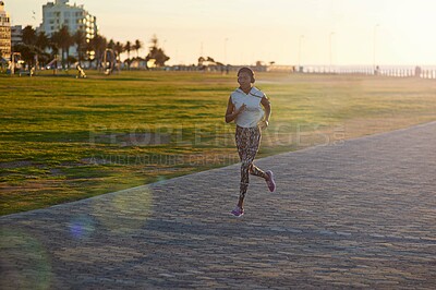 Buy stock photo Black woman, running or outdoor with music for fitness, exercise or cardio training. Girl, headphones or jog on Mozambique promenade for workout, challenge and lose weight with motivational podcast