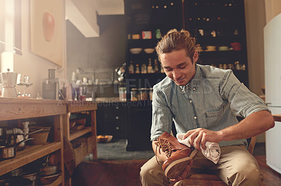 Buy stock photo Man, wiping and polish shoes at house with leather care, fabric shine and maintenance routine for aesthetic. Male person, cloth and vintage footwear with hygiene, style protection and product texture