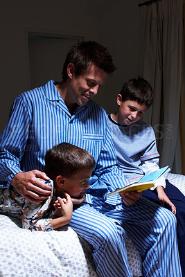 Buy stock photo Kids, father and reading bedtime story, fantasy book or brothers learning in dark home at night. Happy children, dad and storytelling in bedroom for education, fairytale and family bonding together