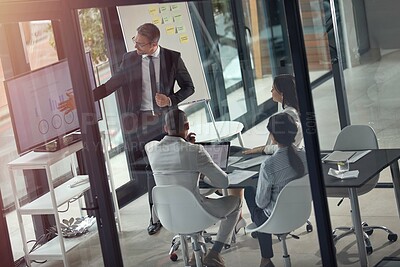 Buy stock photo Shot of a businessman giving a presentation in the boardroom