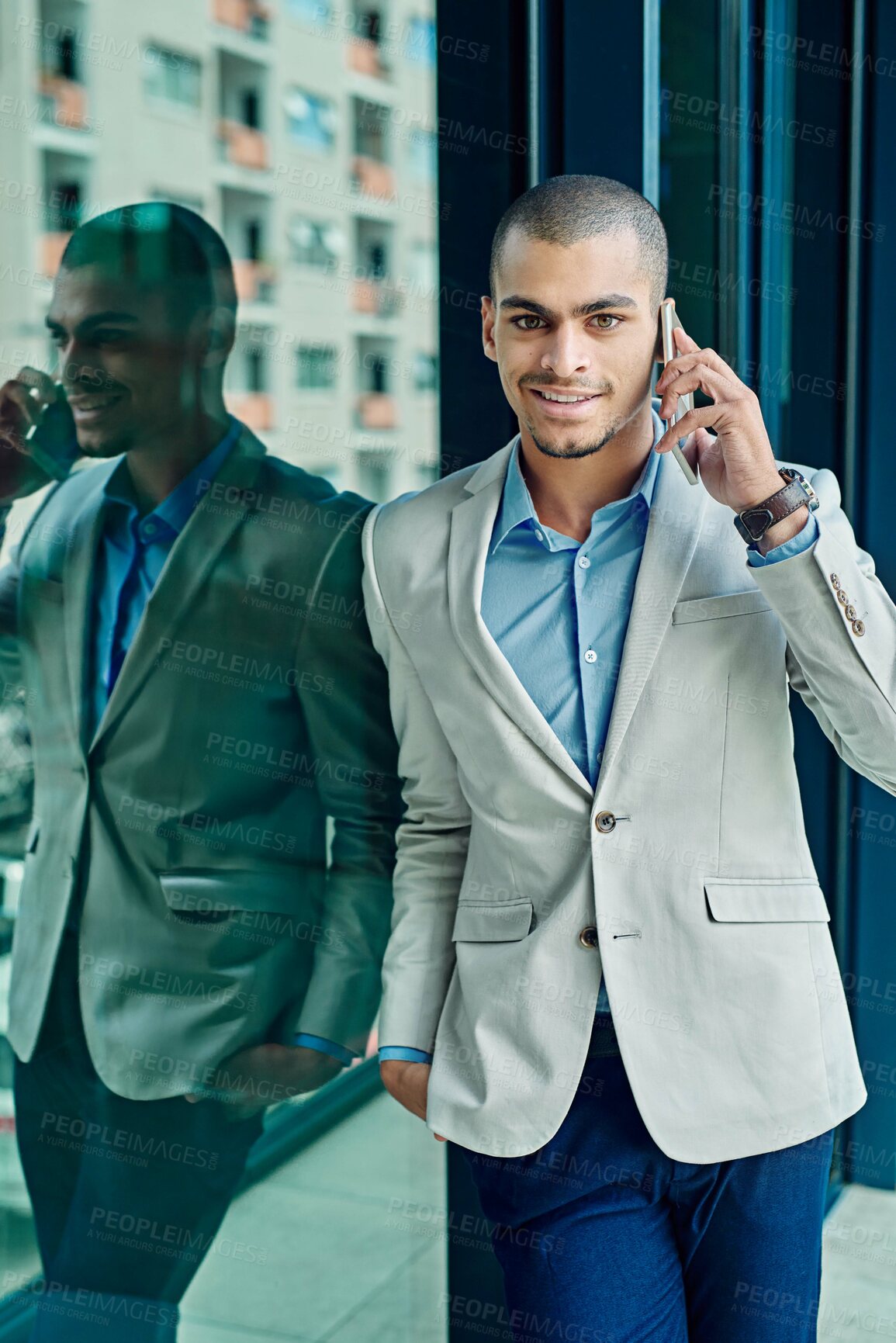 Buy stock photo Portrait of a young businessman using his phone at work