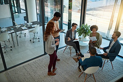 Buy stock photo Shot of a group of creatives having a meeting in a modern office