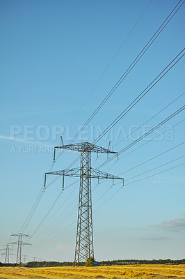 Buy stock photo Outdoor, electricity lines and blue sky for power supply, engineering and industrial energy in countryside. Transmission lines, technology and infrastructure for high voltage distribution to homes