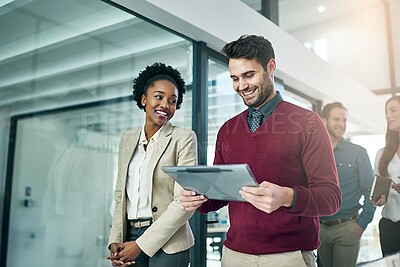 Buy stock photo Shot of a group of colleagues talking together in a large modern office