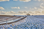 Nature, farm and snow with road for car, destination and outdoor location for winter journey by ice. Pathway, sustainability and adventure with frosty field for vehicle, landscape or travel in Canada