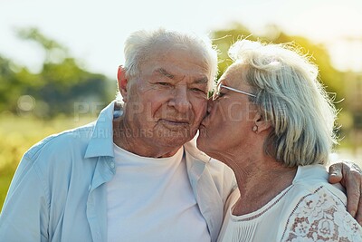 Buy stock photo Love, kiss and senior couple in park with happy, smile and bonding in nature together. Senior man, woman and romance in garden with trust, support and security for fun and retirement commitment