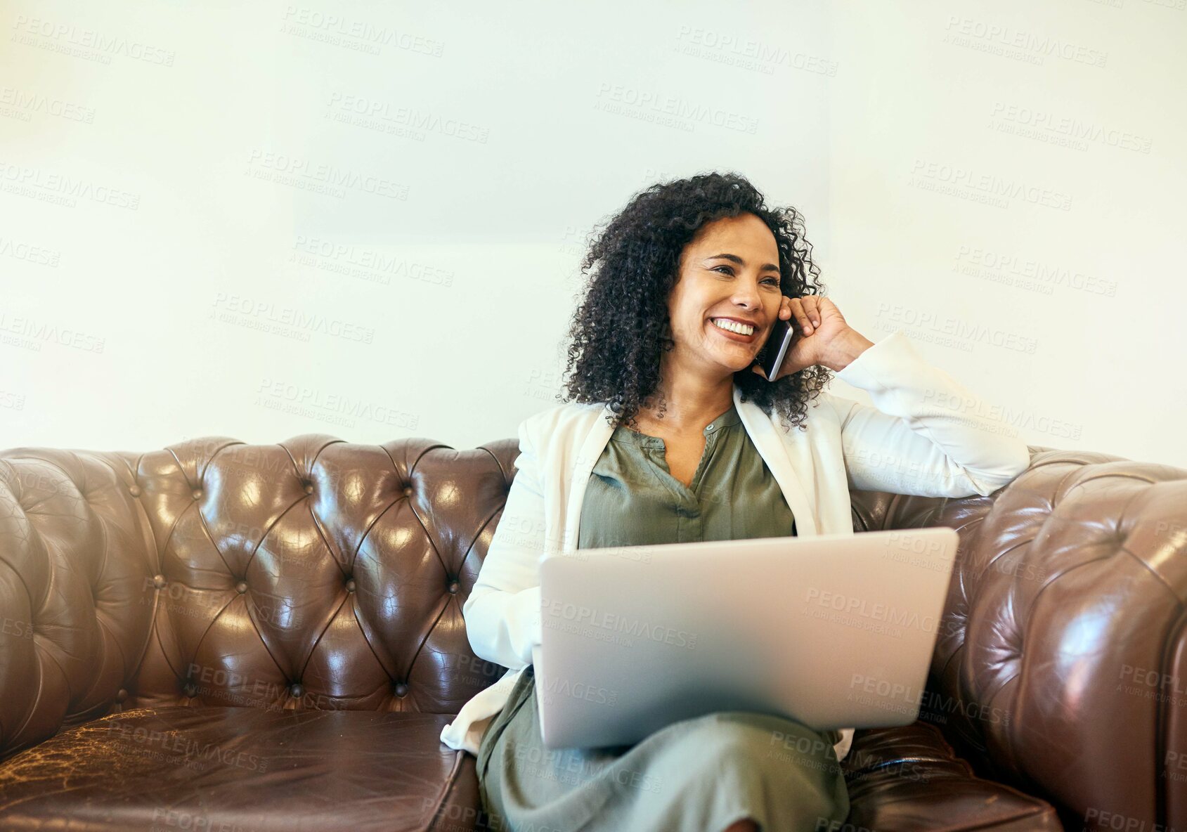 Buy stock photo Happy woman, laptop and talking with phone call on sofa for business discussion, chat or proposal at office. Young, female person or secretary with mobile smartphone or computer for communication