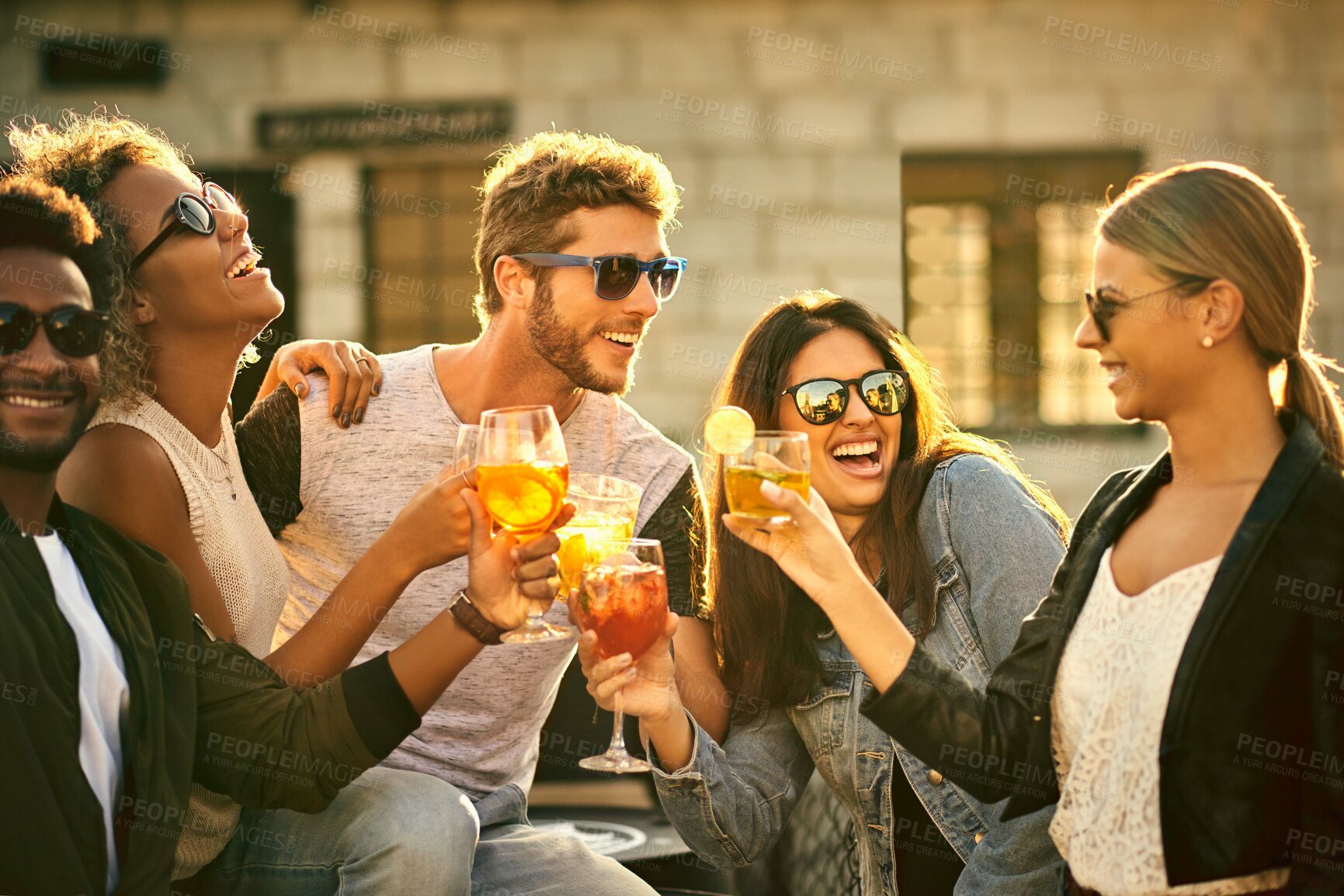 Buy stock photo Friends, city and cheers with drinks at party, social event and celebration of relationship. People, sunglasses and toast with alcohol for bonding in town, diversity and outdoor for love or support