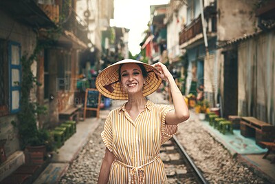 Buy stock photo Happy, straw hat and portrait of woman on vacation, getaway or weekend trip in Vietnam. Smile, travel and female person with traditional non la for souvenir on holiday in city with tourism adventure.