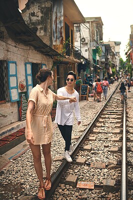 Buy stock photo Couple, romance and walking by railway for travel, relationship and holiday adventure with support. People, trip and happy in Vietnam for vacation, love and holding hands on date with train track