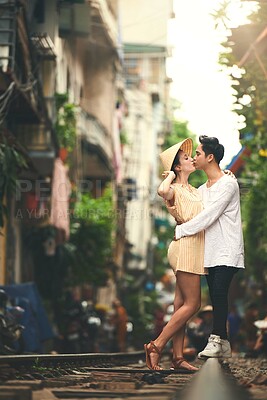 Buy stock photo Kiss, travel and couple in city for vacation, sightseeing and holiday for romance in relationship. Outdoor, love and woman hug man for bonding together in urban town for weekend trip in Vietnam.