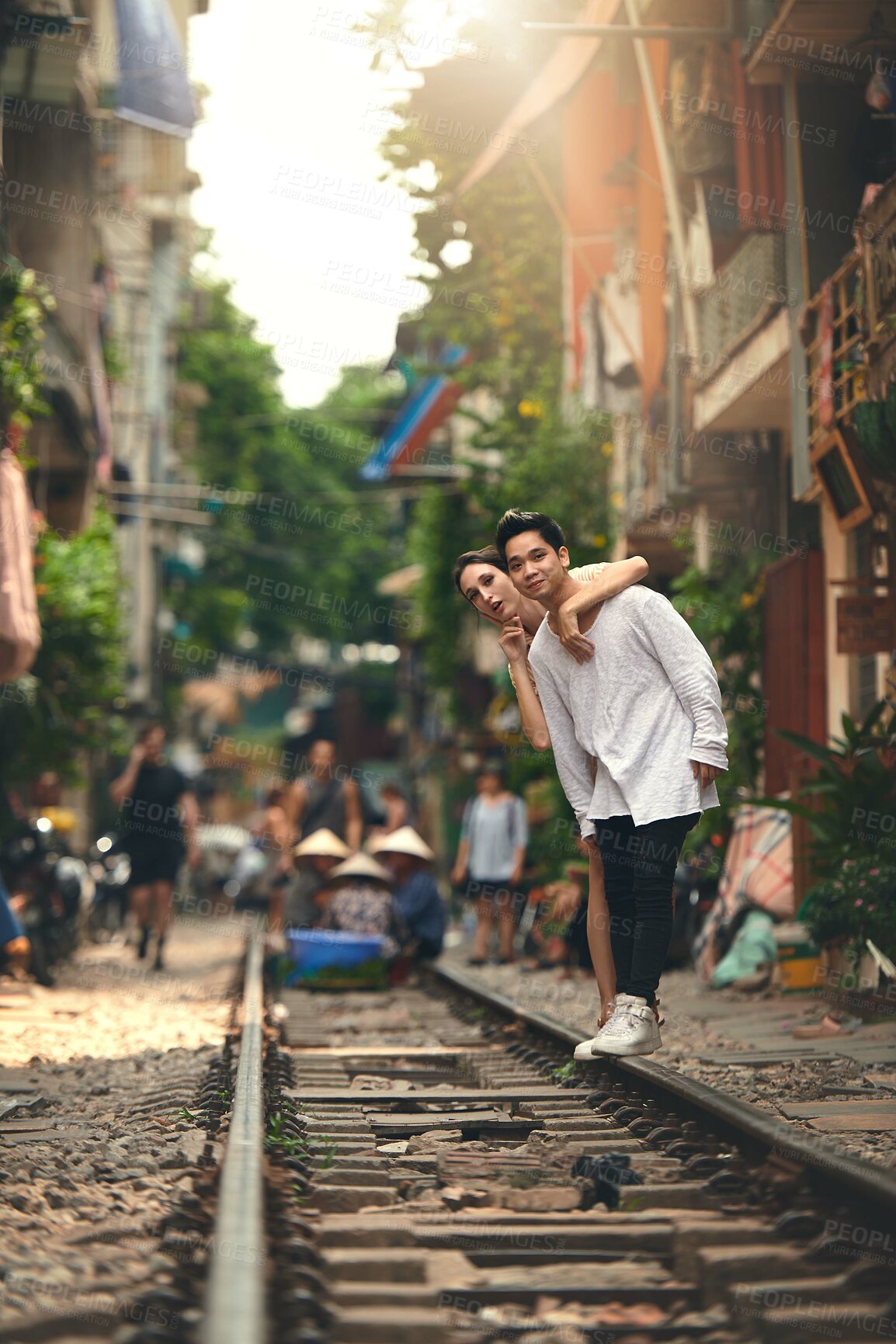 Buy stock photo Travel, city and couple by railway in Vietnam for holiday, vacation and tourist destination. Dating, love and man and woman on train tracks for adventure, journey and explore for bonding together