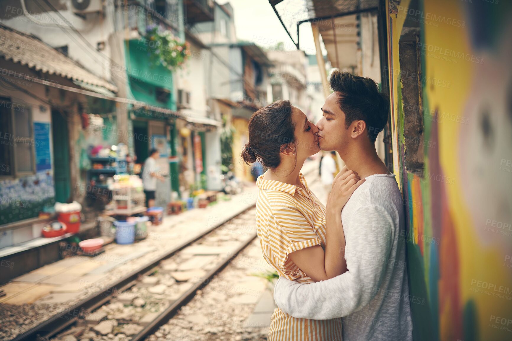 Buy stock photo Couple, kiss and travel by train station in city for romance, affection or love on vacation. Woman, man and together on railway for holiday, adventure or outdoor on platform as sightseeing in Vietnam
