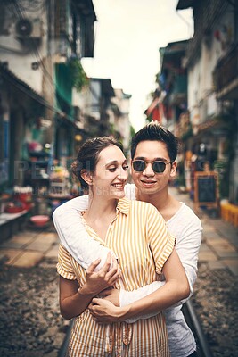 Buy stock photo Couple, love and hug for travel, relationship or holiday adventure with embrace or support in city. People, trip and happy in Vietnam for vacation, romance and anniversary on date with smile or trust