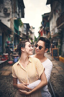 Buy stock photo Couple, happy and hug in city for love, romantic gesture or healthy relationship with trust. Man, woman and support on Vietnam railway for sweet moment, affection and travel outing with commitment