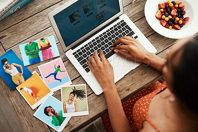 Buy stock photo High angle shot of an unrecognizable businesswoman sitting in her home office and blogging from her laptop