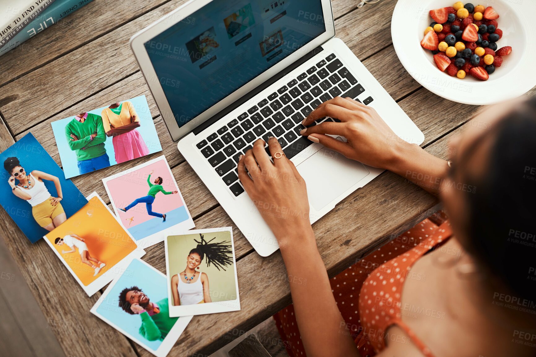 Buy stock photo High angle shot of an unrecognizable businesswoman sitting in her home office and blogging from her laptop