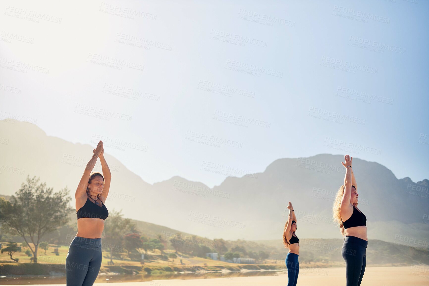 Buy stock photo Stretching, yoga and women in nature in morning for wellness, peace and mindfulness on beach. Friends, pilates and people by ocean for exercise, meditation and workout for health, balance and calm