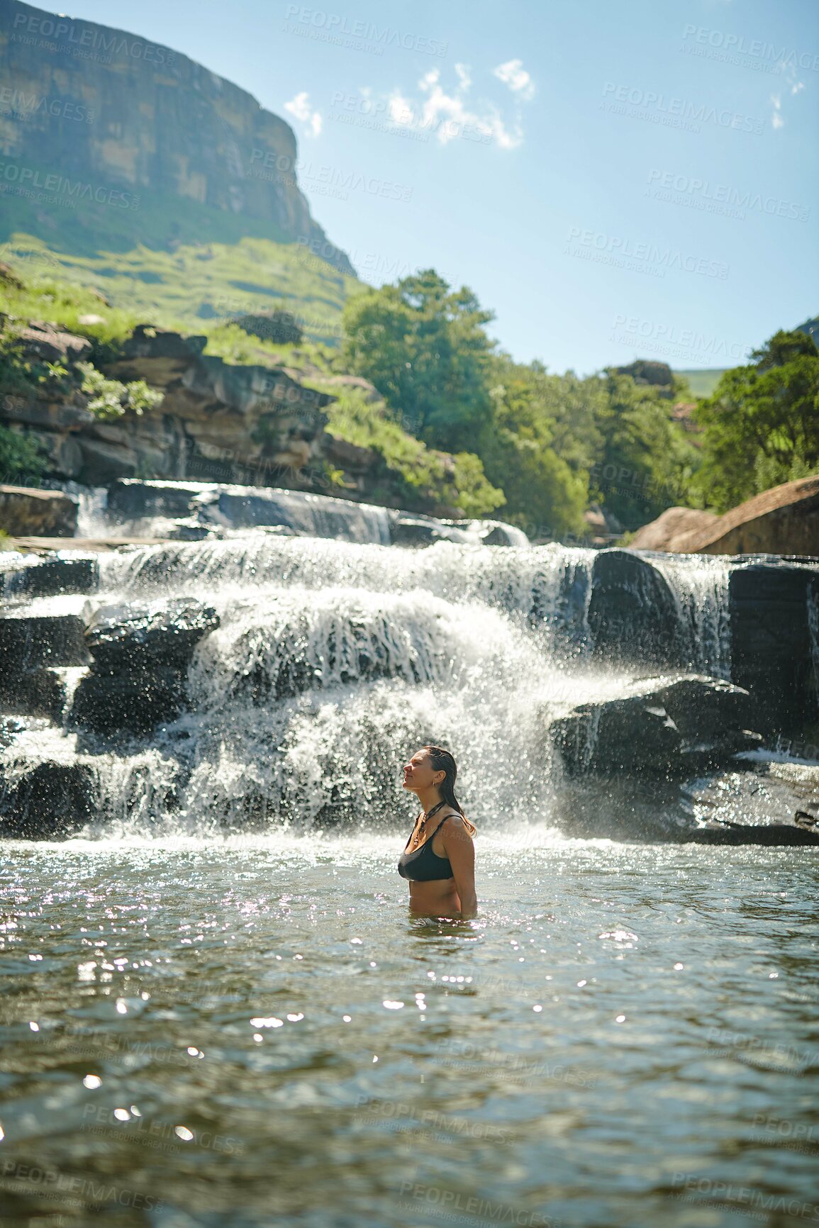 Buy stock photo Waterfall, thinking and woman on mountain for adventure at travel destination, nature and tourism outdoors. Happy, journey and person relax in water, dam and stream for holiday, vacation and swimming