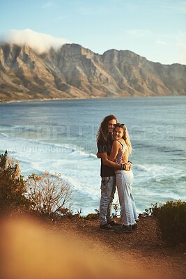 Buy stock photo Ocean, portrait and couple with hug on adventure, travel vacation and bonding together with love. Mountain, man and woman with smile for anniversary, connection and holiday with affection with trust