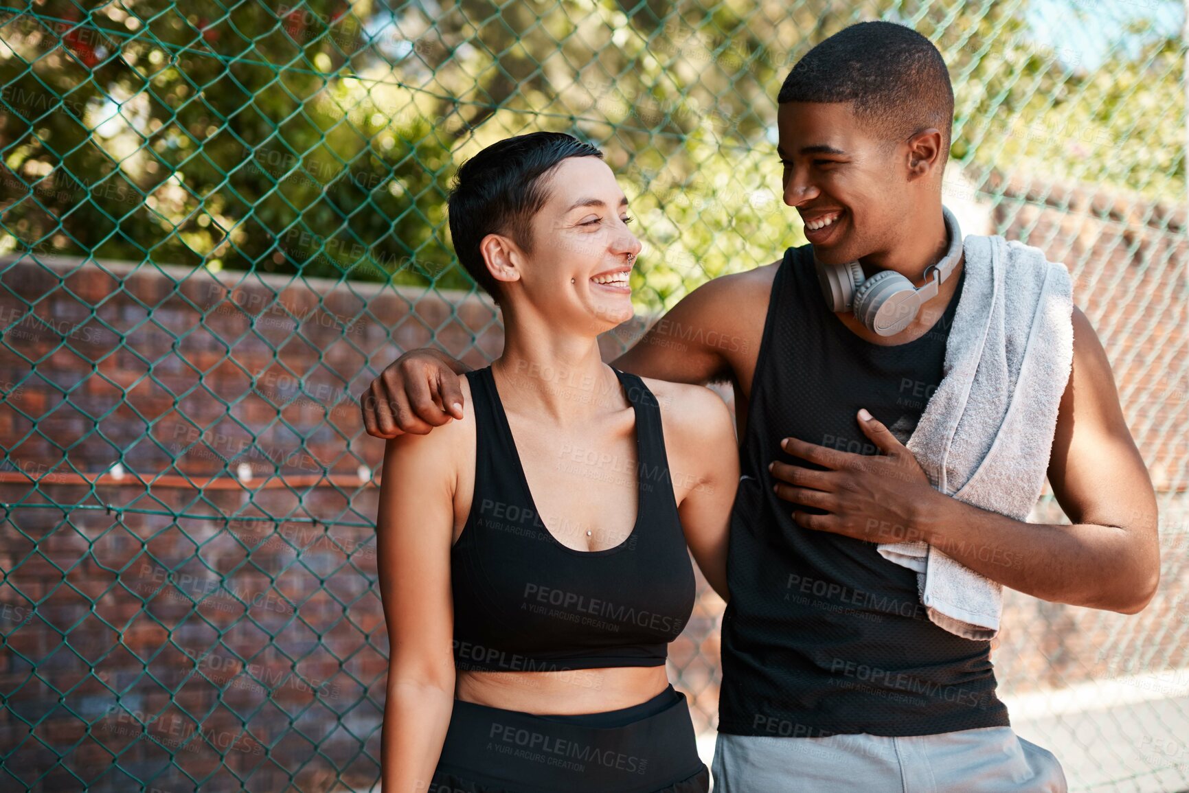 Buy stock photo Happy, fitness and laugh with interracial couple on court for sports training, health and teamwork. Workout, personal trainer and exercise with man and woman for wellness, summer and performance