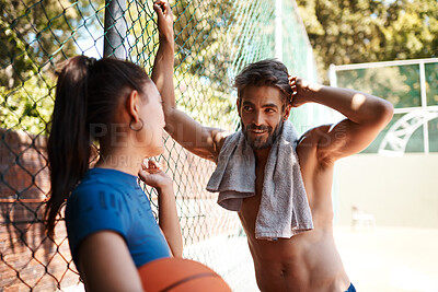 Buy stock photo Basketball, exercise or talking with couple on court together for sports or training. Break, conversation or fitness with man and woman athlete player people outdoor at venue for shirtless workout