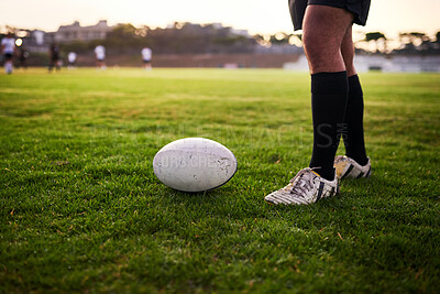 Buy stock photo Fitness, legs and ball for rugby, outdoor and performance for game, stadium and kick for competition. Professional, athlete and person with goals, campion and feet for match, cardio and football