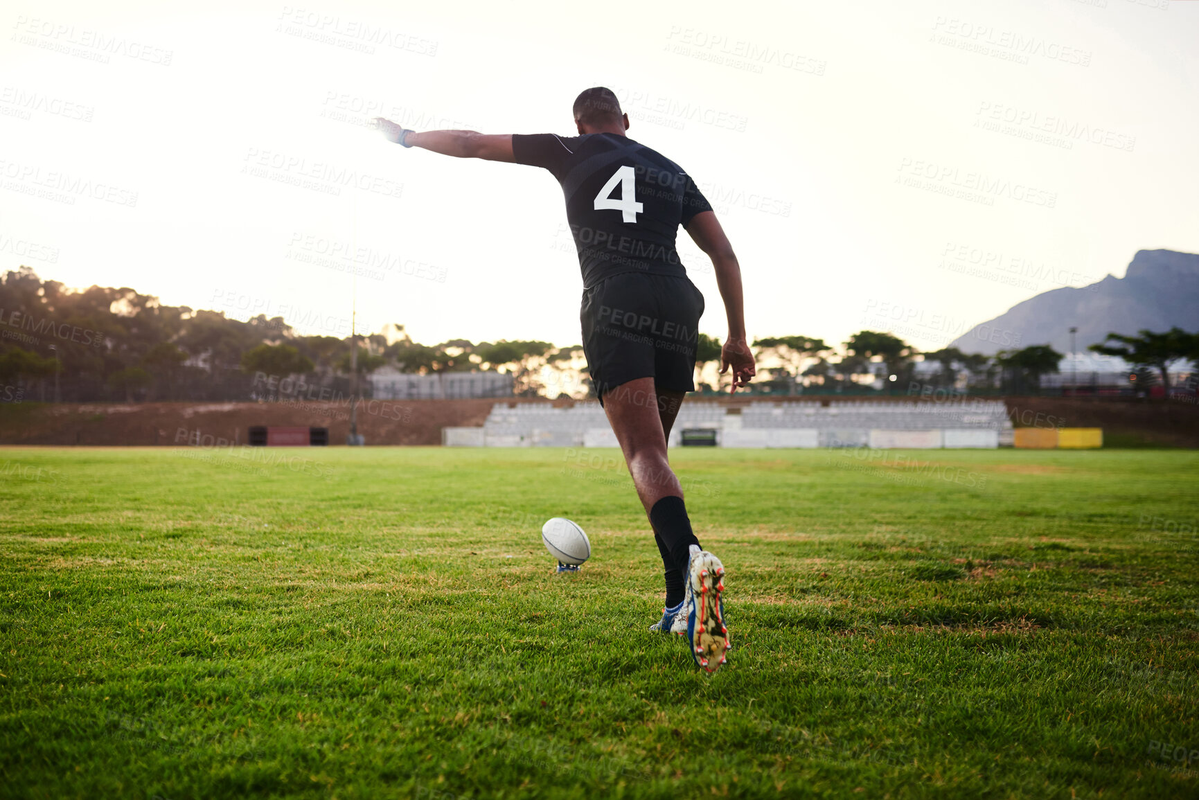 Buy stock photo Rugby, man and kick for match, outdoor and performance for game, stadium and player for competition. Professional, field and person with goals, campion and back of athlete, cardio and football