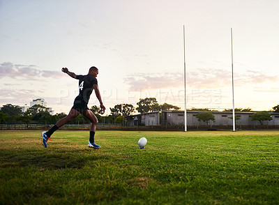 Buy stock photo Rugby, man and kick for match, fitness and performance for game, stadium and player for competition. Professional, field and person with goals, campion and back of athlete, cardio and football