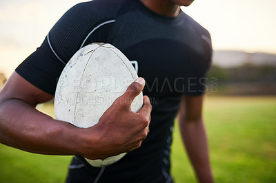 Buy stock photo Rugby, man and hand on field with ball, training ambition and ready for tournament. Closeup, sport and athlete on stadium grass for fitness, game competition and skill development in New Zealand