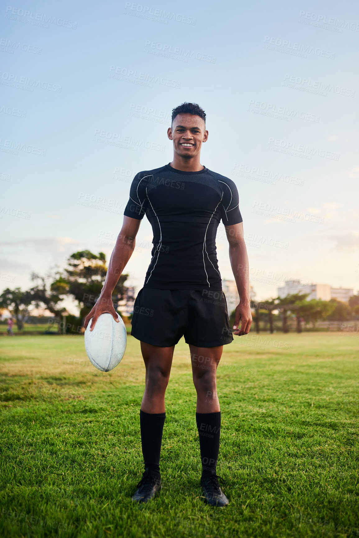 Buy stock photo Rugby, portrait and happy man with ball for sports, game or competition at pitch. Player, smile and confidence of athlete at field for training match, exercise and fitness workout outdoor in Brazil