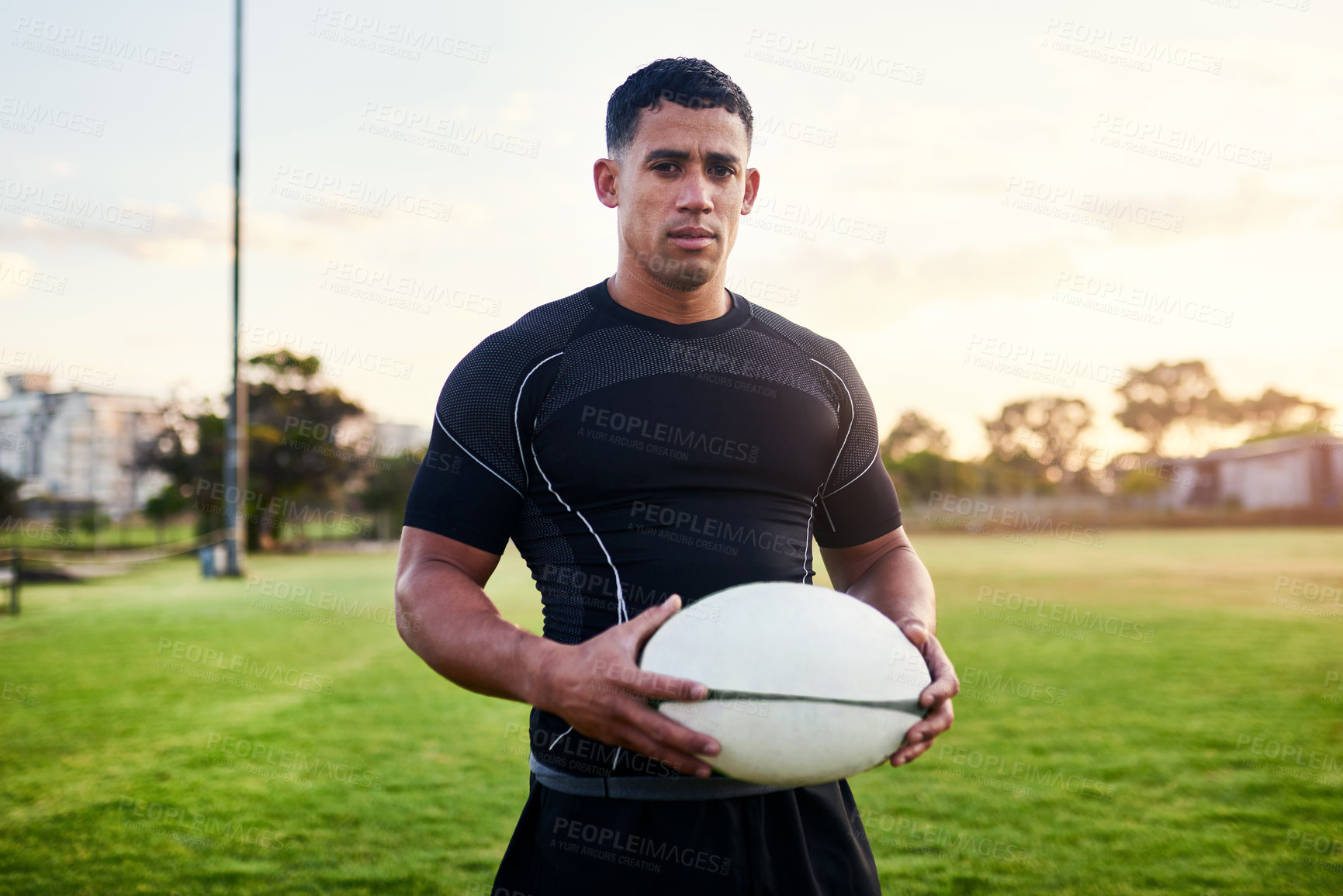 Buy stock photo Rugby, portrait and man with ball for sports, game or competition at pitch at sunset. Player, determination and confident athlete at field for body health, exercise and fitness outdoor in Argentina