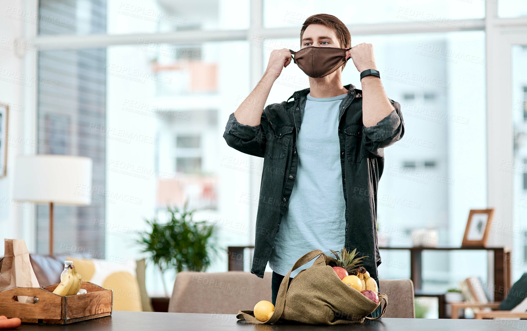 Buy stock photo Face mask, grocery and health with man in house for shopping, virus prevention and safety. Supermarket, wellness and bacteria with person at home for vegetables, food and allergy protection.