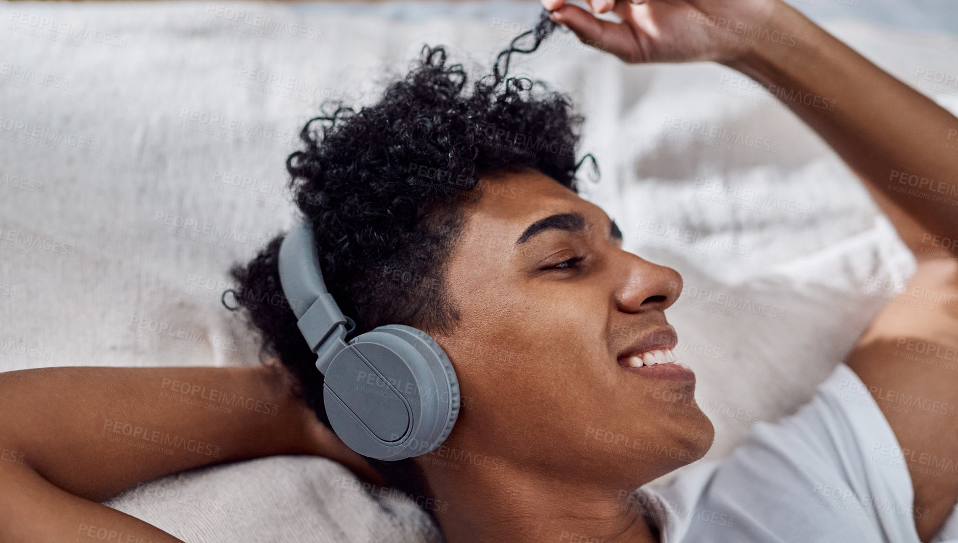 Buy stock photo Smile, relax and man listening to music on headphones, audio and touch hair in home. Happy, bedroom and person streaming radio, hip hop playlist or rock song with technology for sound subscription