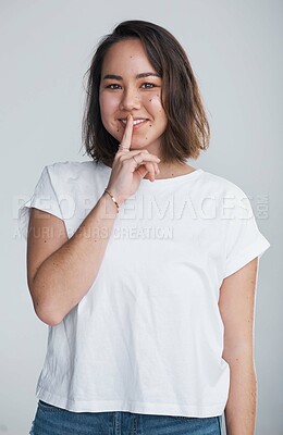 Buy stock photo Asian woman, portrait and finger with hush, studio and silence for mystery announcement. Model, gossip and secret with rumor, whisper and gesture for news or noise with privacy on white background