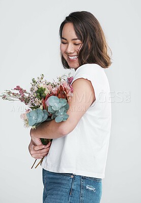 Buy stock photo Smile, thinking and woman in studio with flowers for event, gratitude and gift of natural plants. Prize, award and happy girl with floral bouquet for anniversary, celebration and white background