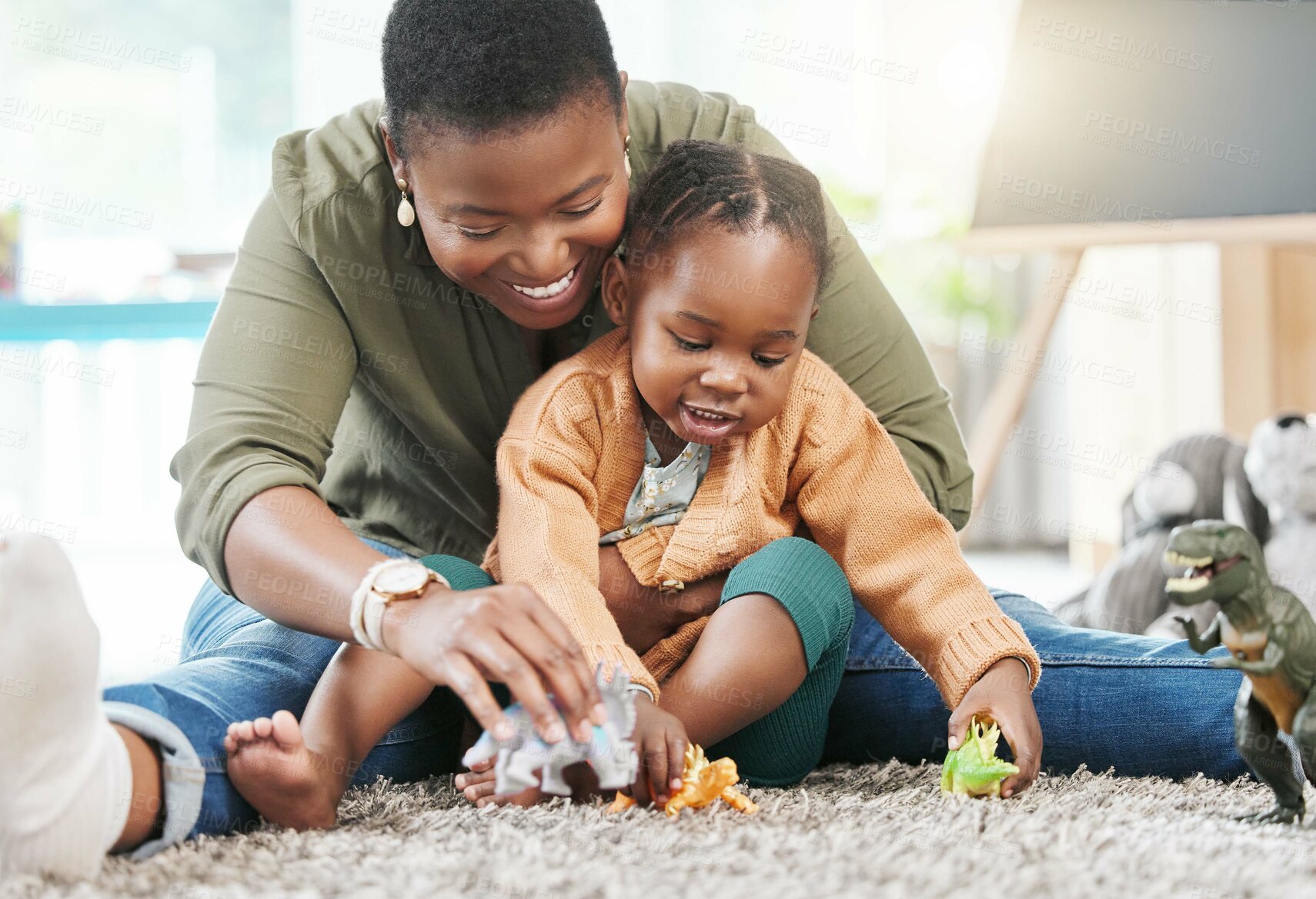 Buy stock photo Black woman, teacher and girl with playing in kindergarten with toys for fun, education and child development. People, educator and happy on floor at school with support, care and help in day care