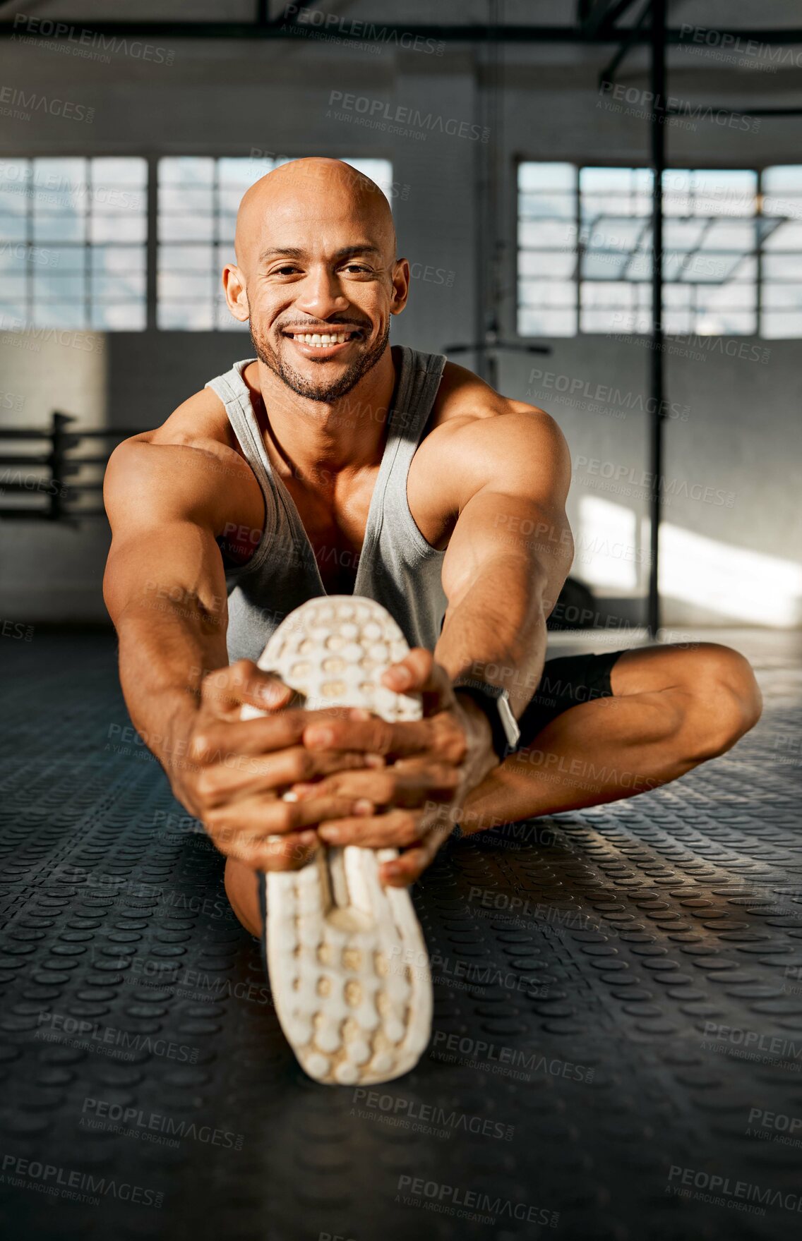 Buy stock photo Portrait, man and legs with stretching for balance, fitness and prevention of muscle tension. Gym floor, smile and bodybuilder with warm up for wellness, workout journey and exercise for development